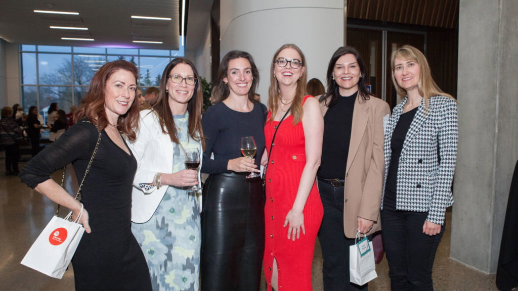 A group of six Women United supporters gather to celebrate connection, collaboration, and their shared dedication to empowering women and girls at Women United’s MindFULL event in May 2024.