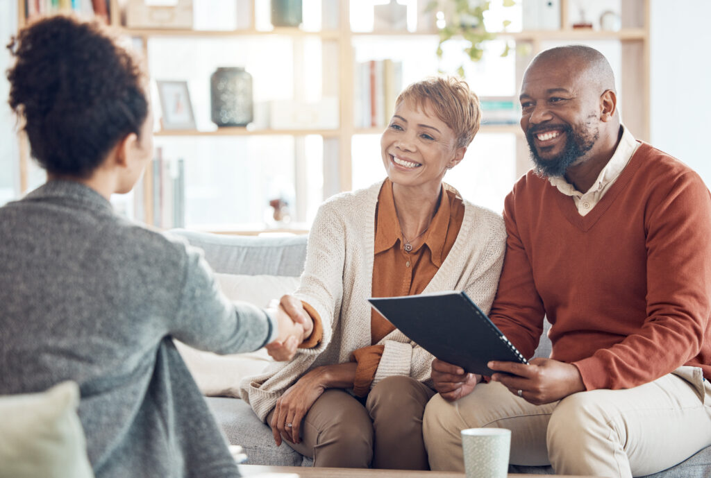 Business meeting, welcome handshake and couple meet with lawyer or financial advisor. Elderly married man, wife and woman retirement conversation, planning and insurance documents for estate finance.