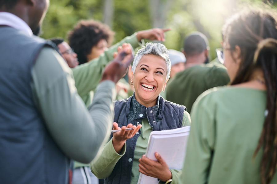 Older woman leading community service group and taking action. 